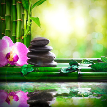 Stacked stones on bamboo reflected in water massage and relax