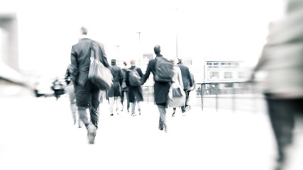 Bleached commuters. High key, abstract captures of business commuters during early morning London rush hour.  Long exposure creating a motion blur to emulate the movement of the scene.