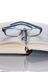 Eyeglasses and pen on the book
