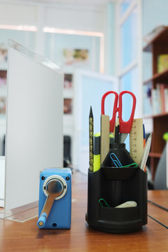 Office supplies including a scissors, sharpener