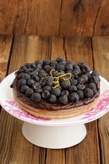 Tasty homemade chocolate pie with ganache, decorated with many f