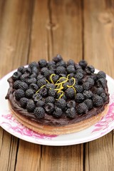 Fresh homemade chocolate pie with ganache, decorated with fresh