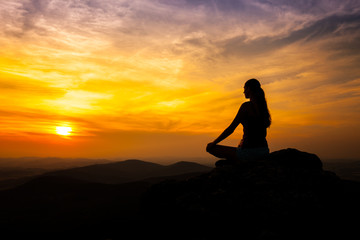 Yoga practicioner in sunset