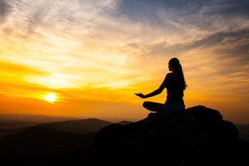 Yoga practicioner in sunset