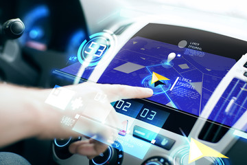 male hand using navigation system on car dashboard