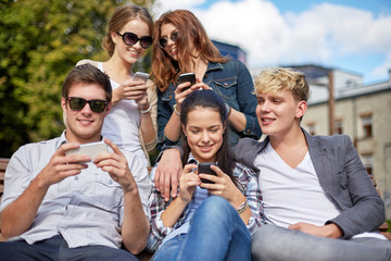 students or teenagers with smartphones at campus