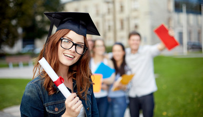 group of smiling students with diploma and folders