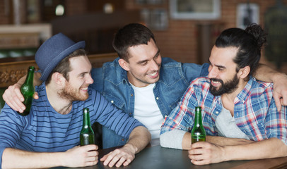 happy male friends drinking beer at bar or pub