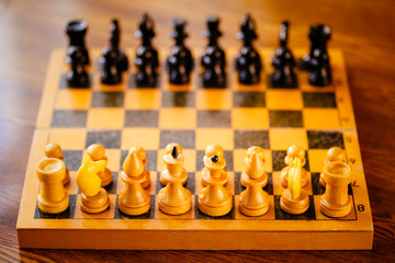 Ancient wooden chess standing on chessboard © Great Brut Here