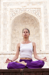 Woman practising yoga meditation at Taj Mahal