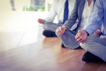 Close up view of business people doing yoga 
