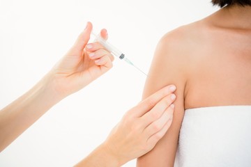Obraz na płótnie Canvas Woman receiving injection on arm 