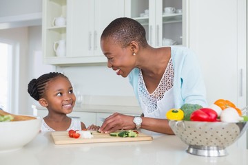 Mother and daughter making a salad together 