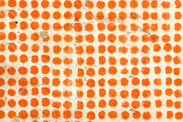 Orange dot pattern on a wall.