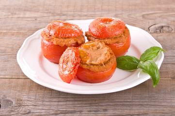 Stuffed tomatoes on a white plate. 