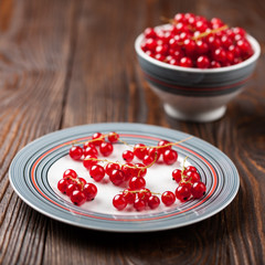 Red currant on a plate and in the bowl
