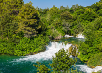 Fototapeta premium Krka waterfalls in the forest on a sunny day.