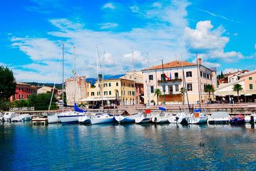 Fototapeta na wymiar BARDOLINO, LAKE GARDA, ITALY - CIRCA AUGUST 2007 -View of marina and Port promenade of Bardolino..