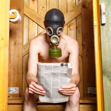 Nude Man In Gas-mask Sitting In Stinky Toilet In Finland