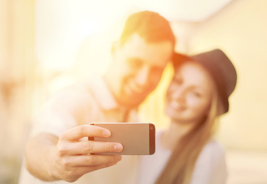Touristic couple shooting on the modile phone selfy at the city