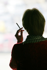 A woman smokes a window
