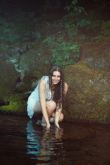Smiling happy woman in a stream
