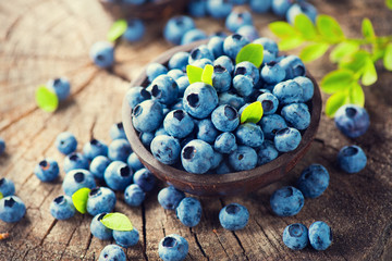 Blueberry on wooden background. Ripe and juicy fresh picked blueberries closeup