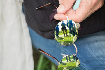 Snapshot. Hiking group at rest reflected on sunglasses