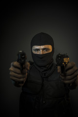 Gangster, Man wearing balaclavas and bulletproof vest with firea