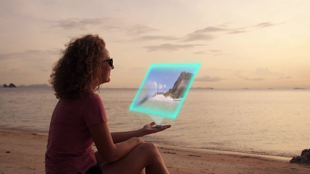 Woman Watching Video with Futuristic Hologramic Media Device. Hi