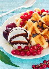 Belgium waffles with chocolate sauce, ice cream and red currants