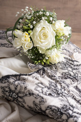 Bouquet of Fresh Flowers on Top of Wedding Gown