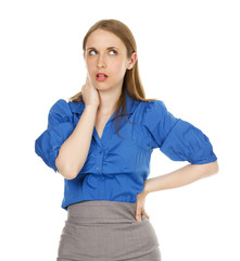 Fototapeta premium An aggravated businesswoman rolling her eyes with one hand on her hip and one on her face.