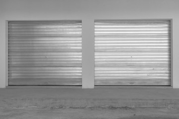 Metal garage doors new installed into new building closeup detail vintage black and white