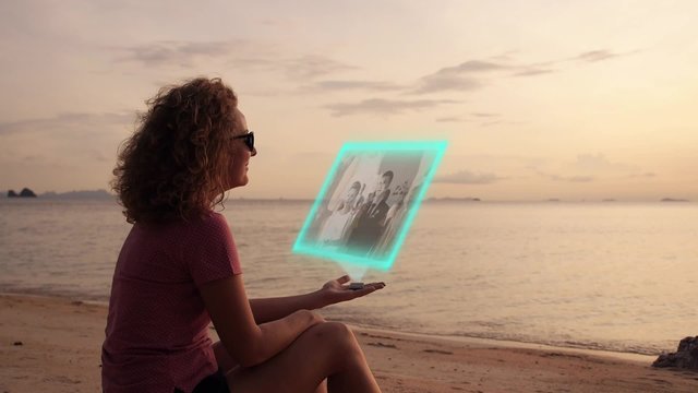 Female Watching Video on Virtual Hologramic Media Device at the
