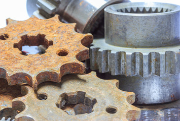 Old rusty cog gear wheel on white background