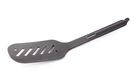 Used black plastic spatula isolated