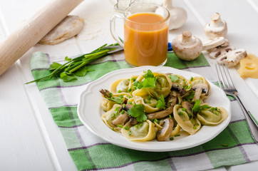 Homemade tortellini with mushrooms and herbs