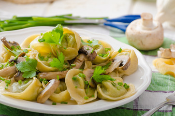 Homemade tortellini with mushrooms and herbs