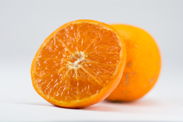 Orange half saw the watery orange juice. The fruit is refreshing