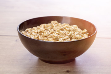 black bowl of cereals on a wood table