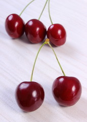 Fresh cherries on white wooden table, healthy food