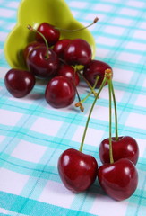 Fresh cherries on checkered tablecloth, healthy food