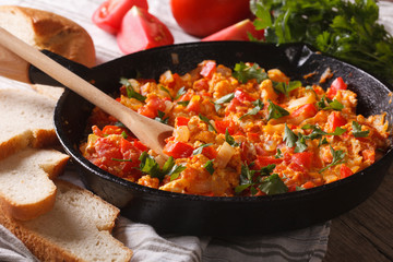 Turkish omelet with vegetables close-up in a frying pan. Horizontal
