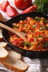 Turkish omelet with vegetables close-up in a frying pan. vertical
