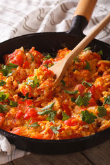 Turkish breakfast: Menemen in a pan close-up vertical

