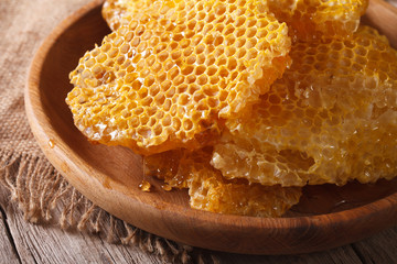 Fragrant honeycomb on wooden plate close up. horizontal