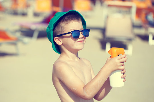Little Kid Applying Sunscreen Spray