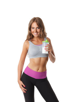 Happy fit woman drinking protein shake