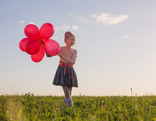 happy girl with red balloons outdoor